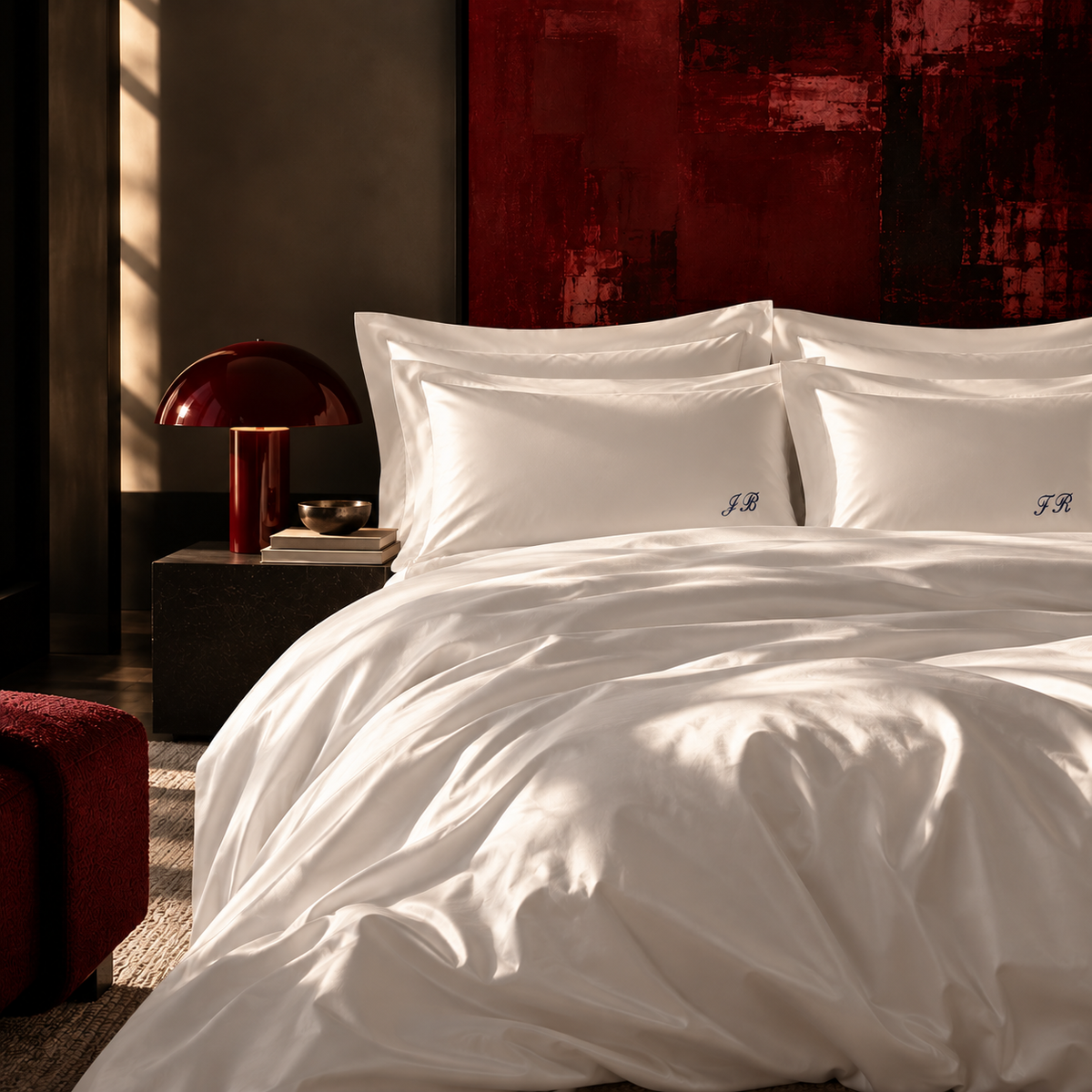 GIZA N°500 Signature monogrammed Egyptian cotton pillowcases with script initials on a made bed
