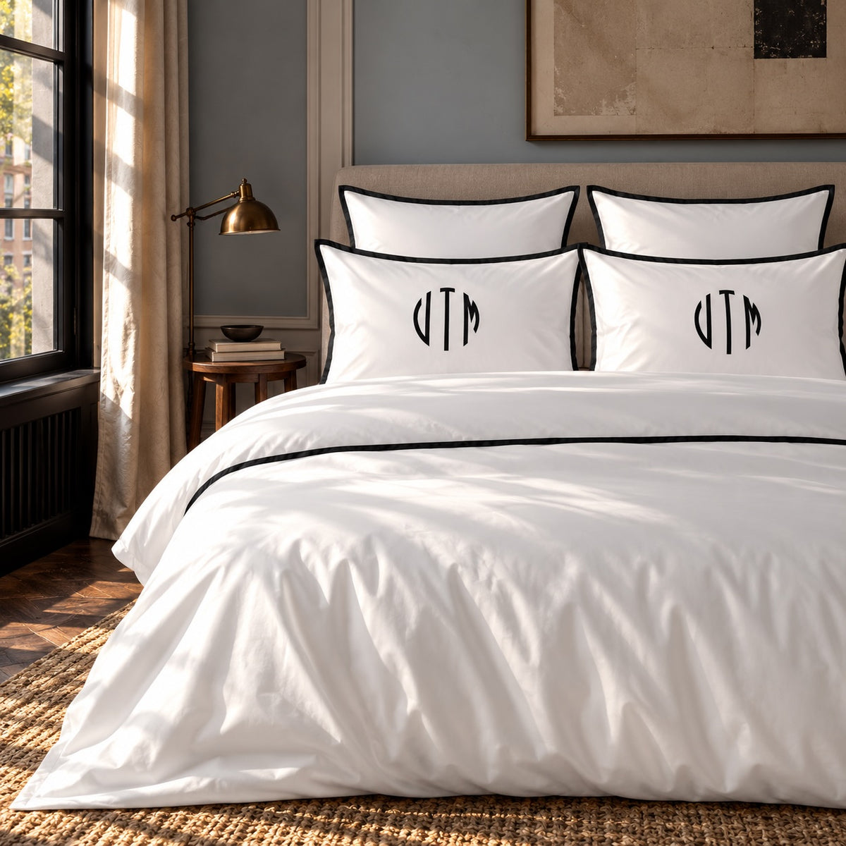 TYPEFACE 6 monogrammed bed sheet set in white 400 TC percale with black satin border and black circle monogram