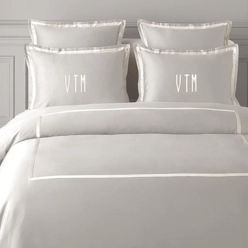 TYPEFACE 4 grey sateen bedding with white satin border and simple monogram pillowcases