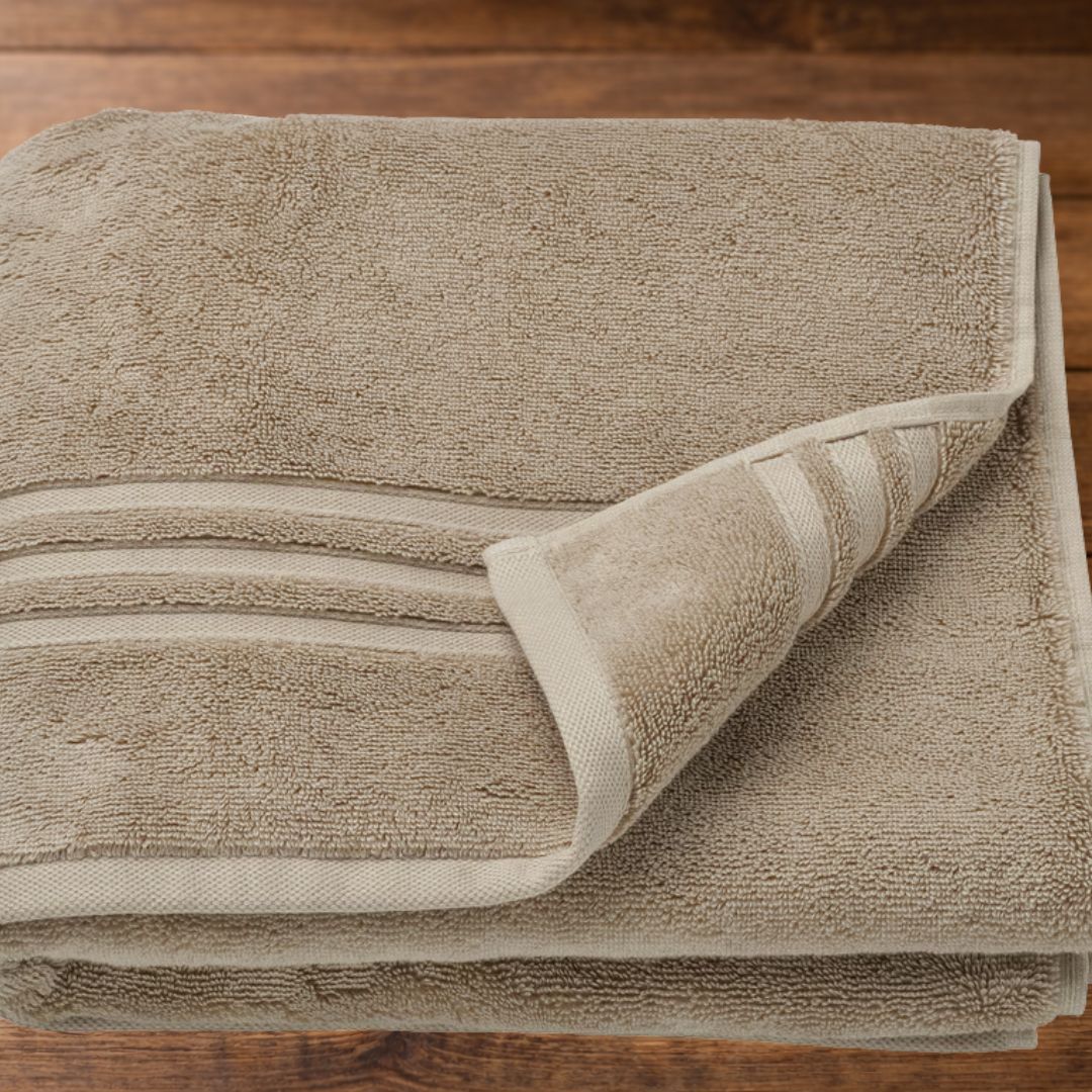 Beige Organic Cotton Bath Towel Folded on Wooden Surface | BEDLAM India