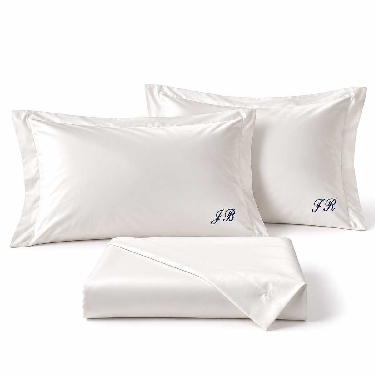 GIZA N°500 Signature folded bed sheet and two flanged pillowcases monogrammed in navy script at the lower right