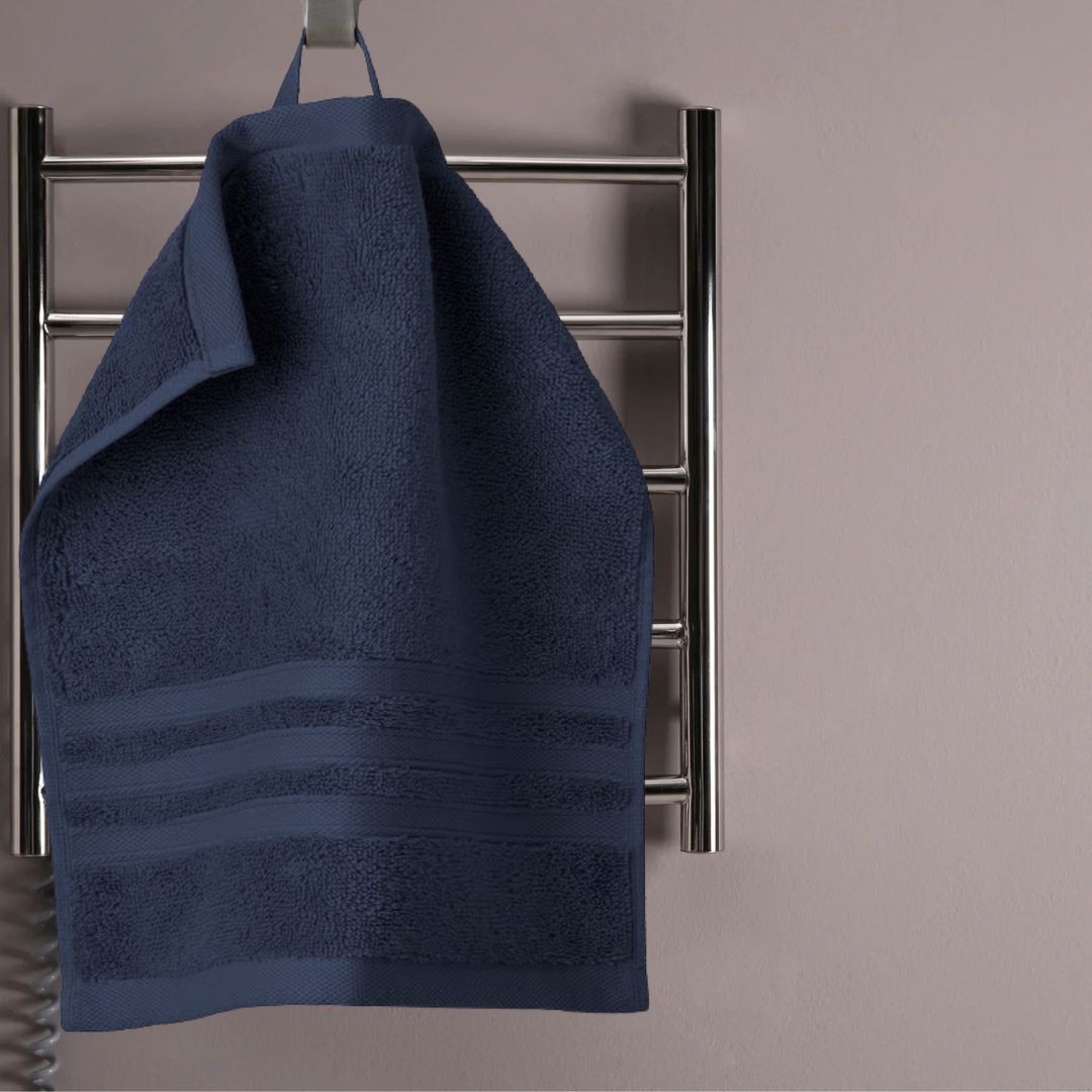 navy blue organic cotton face towel hanging on rack